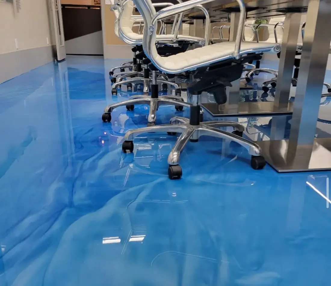 Close-up of a blue metallic floor coating under conference chairs