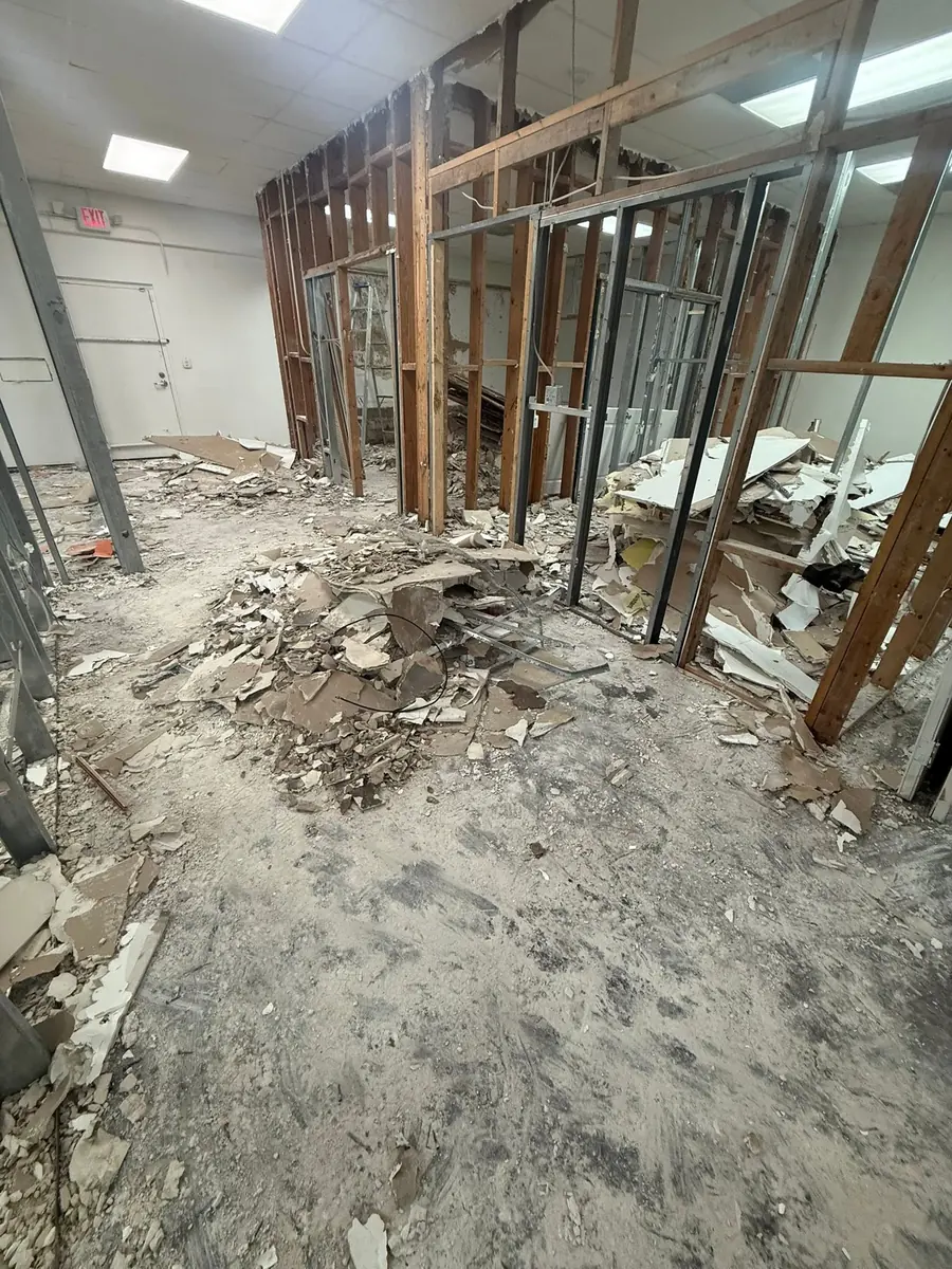 Commercial interior demolition with drywall removed down to the wood and metal stud framing
