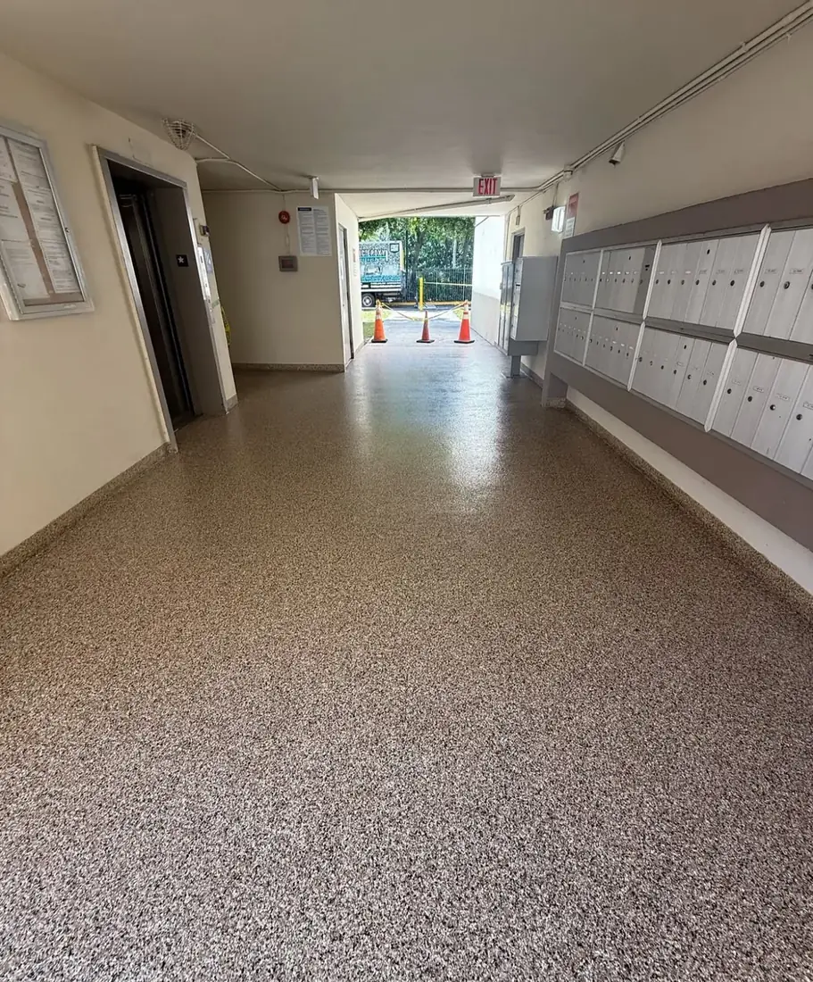 Long lobby corridor with a glossy tan flake floor coating