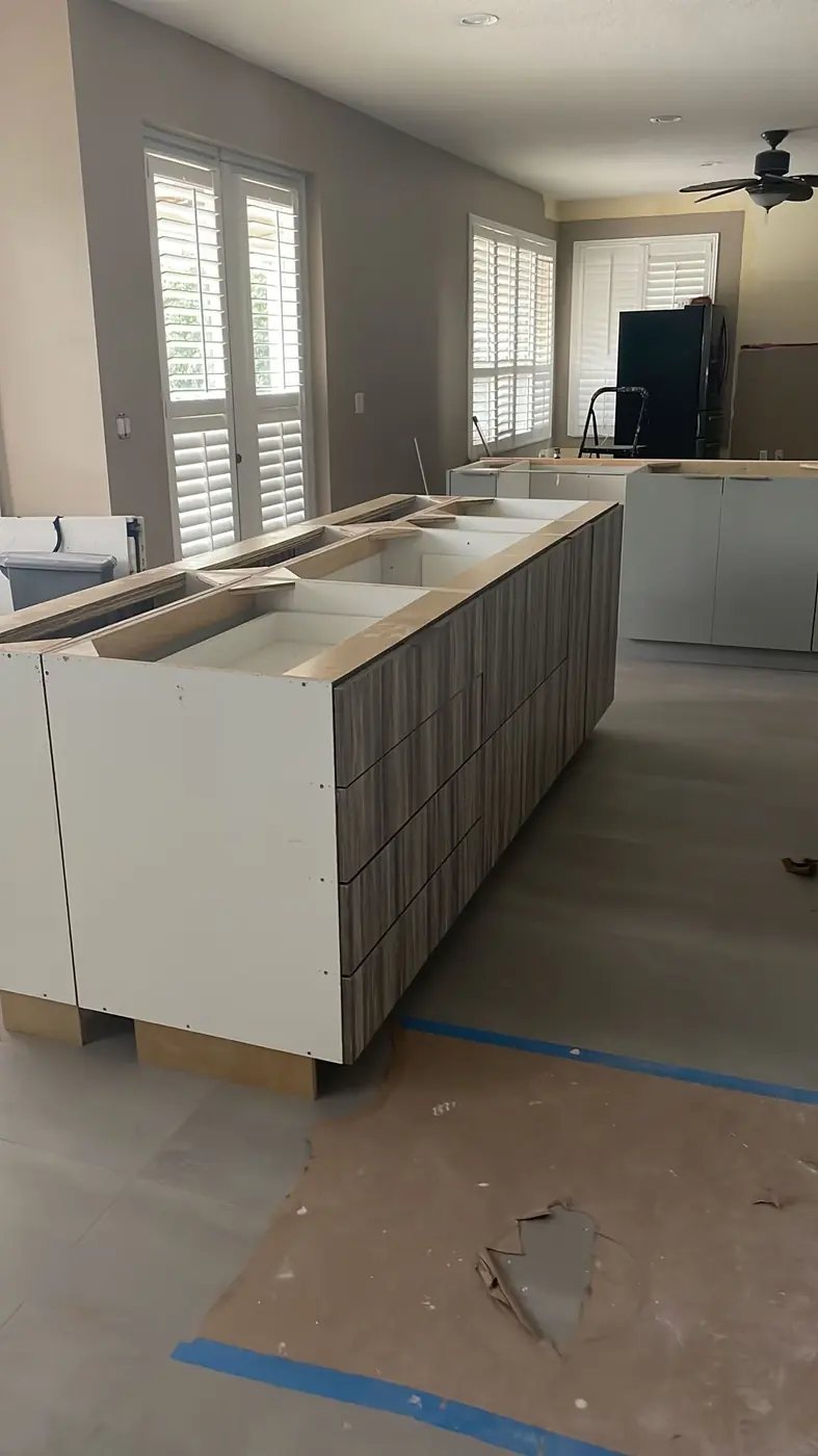Kitchen island with wood-grain drawer fronts installed before the countertop