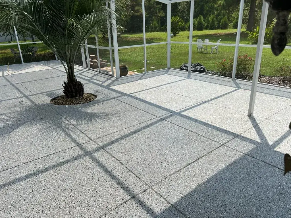 Large screened patio with a light flake coating and saw-cut joints