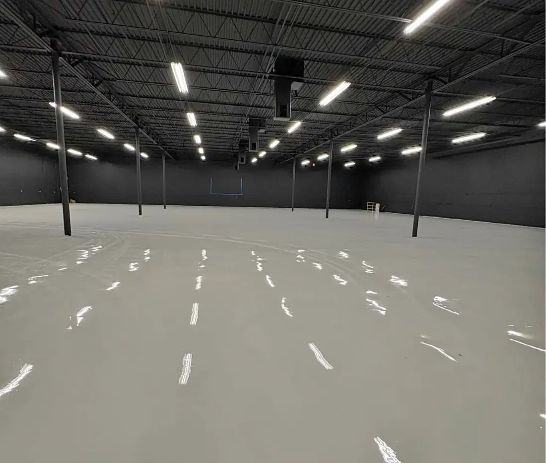 Wide view of a warehouse floor with a glossy solid gray coating