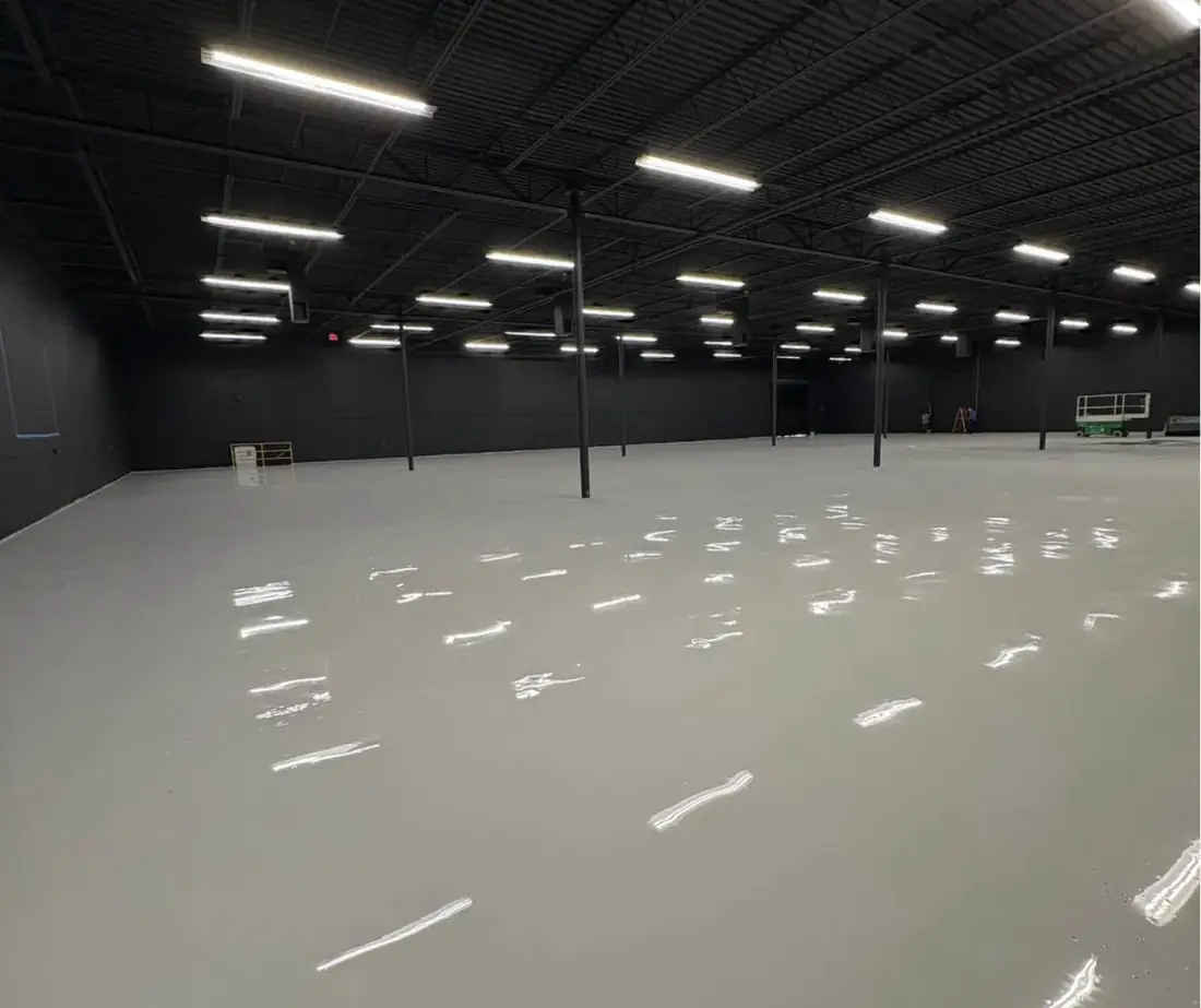 Large warehouse with a glossy solid gray floor coating